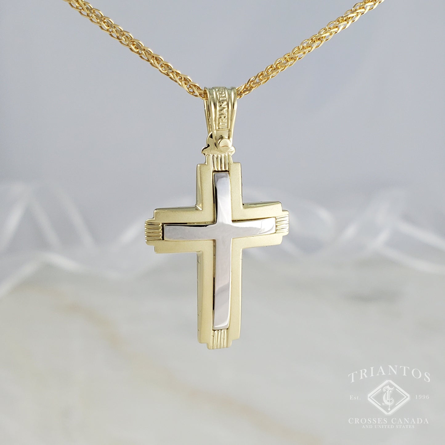 Modern dual tone, white and yellow gold, cross pendant outlined in matte and polish middle finish.