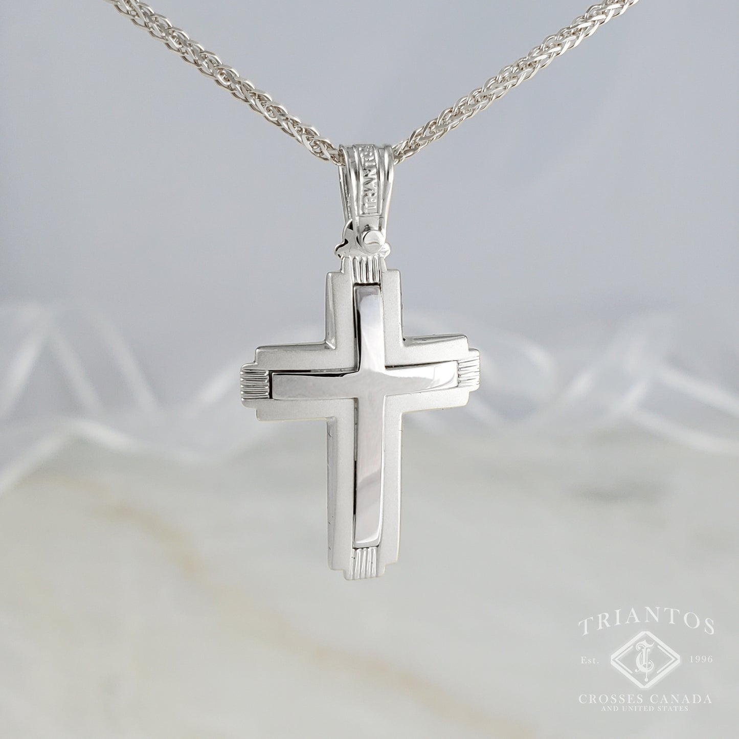 Modern cross pendant outlined in matte and polish middle finish. 